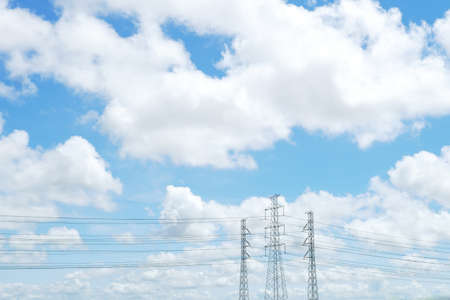 blue sky and white cloud with high voltage transmission towers and power line the electricity infrastructure from power plant to industrial and householdの写真素材