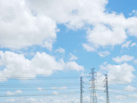 blue sky and white cloud with high voltage transmission towers and power line the electricity infrastructure from power plant to industrial and householdの写真素材