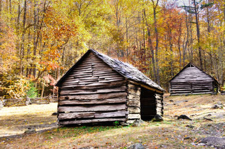 Two historic log cabins in Smoky Mountain National Park with fall colorsの写真素材
