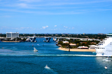 A cruise ship leaving Port Everglades with Ft  Lauderdale in the backgroundの写真素材