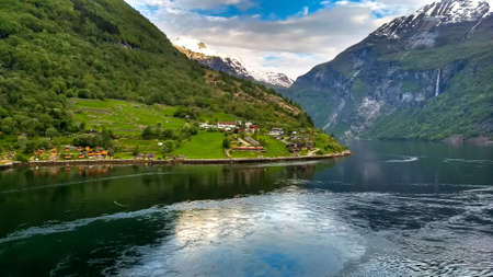 Cruising past a small settelment on the way to Geiranger, Norway.の写真素材