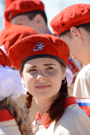 VORONEZH CITY - MAY 19, 2022: pretty schoolgirls in beautifully stylized uniforms of the youth-patriotic movement "Yunarmiya" awaits for the action on the 100th anniversary day of the Soviet pioneersのeditorial素材