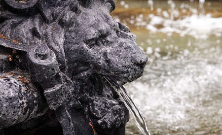 Kiev, Ukraine July 12, 2019: Ancient city fountain with the faces of a lion, Neptune, fishの写真素材