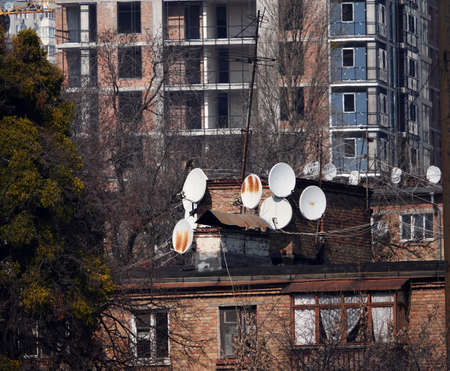 Plates for receiving TV channels on the roofs of housesのeditorial素材