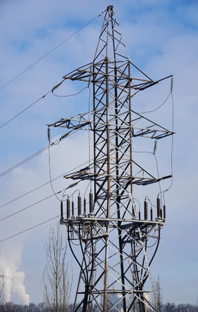 Poles with high-voltage wires against the skyのeditorial素材