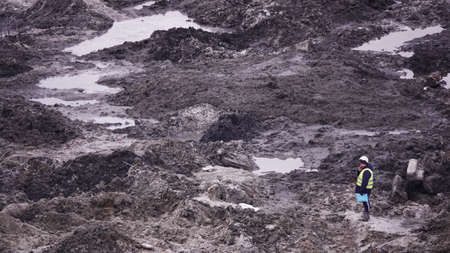 Kiev, Ukraine, October 17, 2018: Workers in the mud of a construction site at the stage of excavation; construction of a supermarket AUCHANのeditorial素材