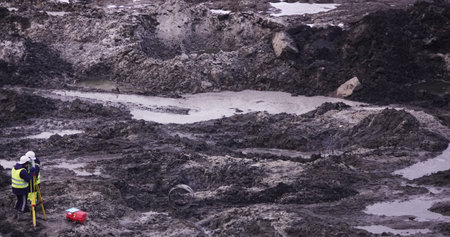 Kiev, Ukraine, October 17, 2018: Workers in the mud of a construction site at the stage of excavation; construction of a supermarket AUCHANのeditorial素材