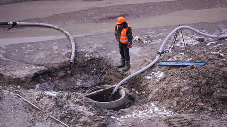 Kiev, Ukraine, October 17, 2018: Workers in the mud of a construction site at the stage of excavation; construction of a supermarket AUCHANのeditorial素材