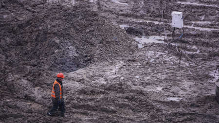 Kiev, Ukraine, October 17, 2018: Workers in the mud of a construction site at the stage of excavation; construction of a supermarket AUCHANのeditorial素材
