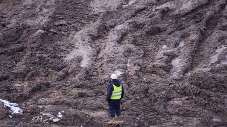 Kiev, Ukraine, October 17, 2018: Workers in the mud of a construction site at the stage of excavation; construction of a supermarket AUCHANのeditorial素材