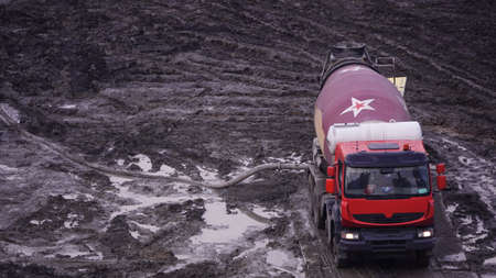 Kiev, Ukraine, October 17, 2018: Workers in the mud of a construction site at the stage of excavation; construction of a supermarket AUCHANのeditorial素材