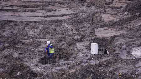 Kiev, Ukraine, October 17, 2018: Workers in the mud of a construction site at the stage of excavation; construction of a supermarket AUCHANのeditorial素材