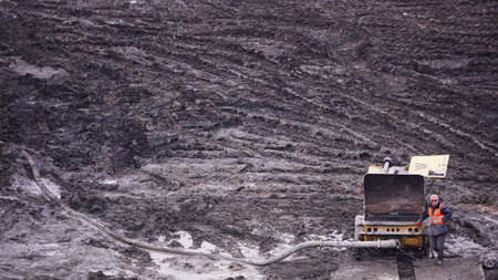 Kiev, Ukraine, October 17, 2018: Workers in the mud of a construction site at the stage of excavation; construction of a supermarket AUCHANのeditorial素材
