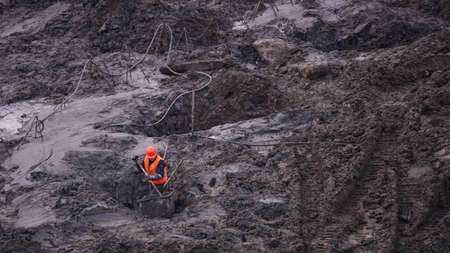 Kiev, Ukraine, October 17, 2018: Workers in the mud of a construction site at the stage of excavation; construction of a supermarket AUCHANのeditorial素材