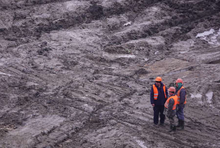 Kiev, Ukraine, October 17, 2018: Workers in the mud of a construction site at the stage of excavation; construction of a supermarket AUCHANのeditorial素材