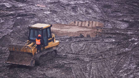 Kiev, Ukraine, October 17, 2018: Workers in the mud of a construction site at the stage of excavation; construction of a supermarket AUCHANのeditorial素材