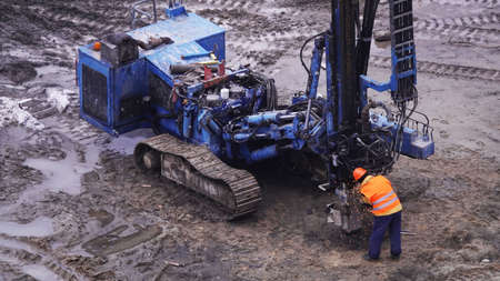 Kiev, Ukraine, October 17, 2018: Workers in the mud of a construction site at the stage of excavation; construction of a supermarket AUCHANのeditorial素材