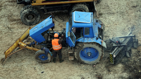 Kiev, Ukraine March 13, 2019: Workers repair equipment on the construction of the zero cycle foundation of the entertainment centerのeditorial素材