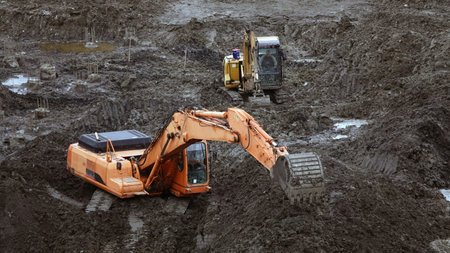Kiev, Ukraine March 13, 2019: Workers and machinery - zero-cycle construction of the foundation of an entertainment centerのeditorial素材