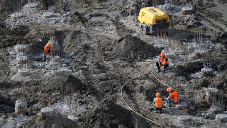 Kiev, Ukraine March 13, 2019: Workers and machinery - zero-cycle construction of the foundation of...