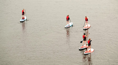 Kiev, Ukraine June 20, 2020: Girls go in for sports SUP - surfing on the water