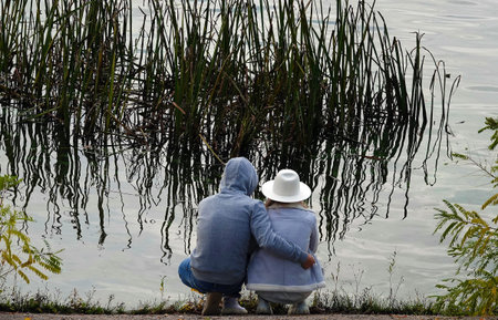 Kiev, Ukraine October 24, 2020: A girl and a guy are hugging in a secluded place looking at the...