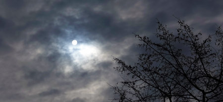 The sun breaks through the dark sky