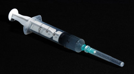 COVID-19 coronavirus vaccine and syringe filled for vaccinationのeditorial素材