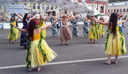 Kiev, Ukraine July 6, 2019: Girls in Hawaiian folk clothes walk along the crosswalk and dance.のeditorial素材