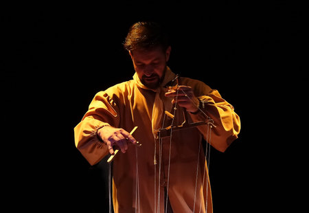 Kiev, Ukraine September 2, 2021: A puppet artist pulling the strings of puppets during a performance