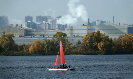 Kiev, Ukraine October 14, 2021: A sailboat boat with red sails floats on the Dnieper river against...