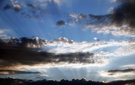 Sky with beautiful cumulus clouds and face image