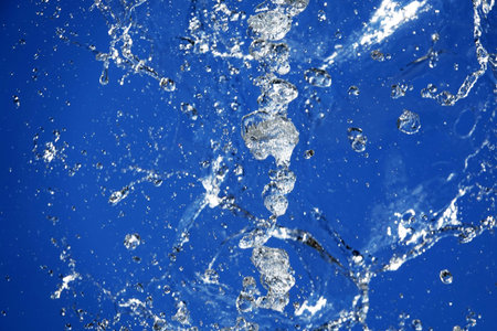 Background - Water in flight on a blue background takes on a variety of unique and bizarre shapes
