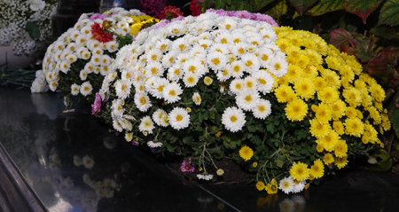 A bouquet of flowers is laid on black marbleの写真素材