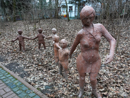 Kyiv, Ukraine January 27, 2025: Sculpture of a woman with children holding hands in a parkのeditorial素材