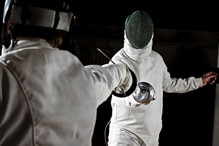  swordsmen fencing.