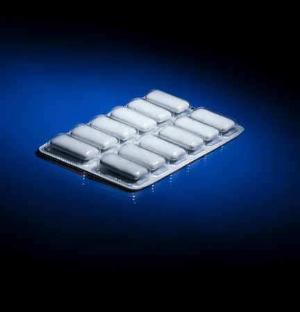 A package of nicotine gum on dark blue background fading to black.