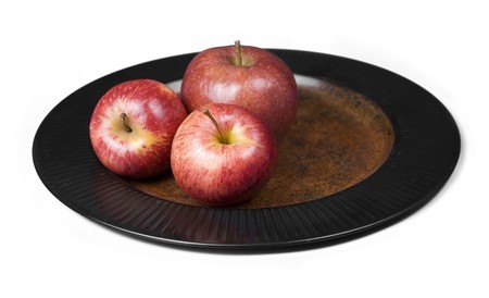Three healthy apple  fruits on a plate. Isolated on white background.の写真素材