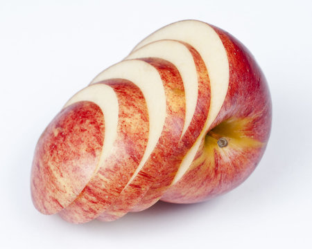 A sliced red apple isolated on white background.