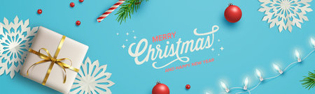 Blue Christmas background with Christmas decor including lights, baubles, gift box, fir tree cuttings, glitter, berries and candy vane. Vector Illustration.のイラスト素材