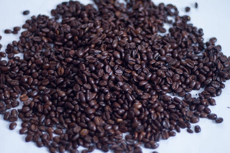 a lot of brown roasted arabica coffee beans as backgroundの写真素材