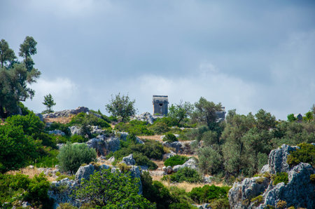 Ancient stone tomb on the island of Kekova in city of Simena, Turkey. Old concrete cemetery on the...