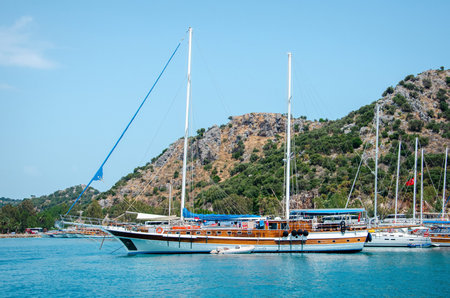 Tourist ship on the background of a beautiful summer mountain landscape on the Mediterranean sea....