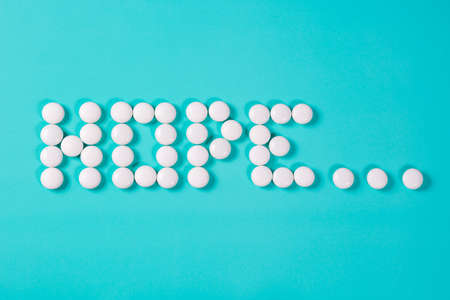 The word hope is made of painkillers white pills on  blueの写真素材
