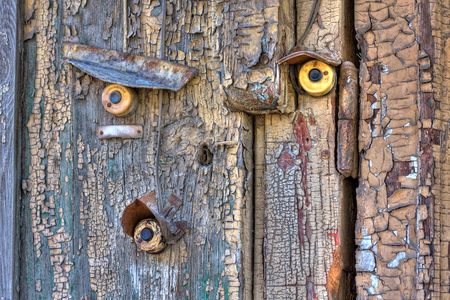 Old wooden door with three bellsの写真素材