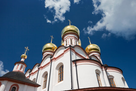 Cupolas of Russian orthodox church against blue sky.