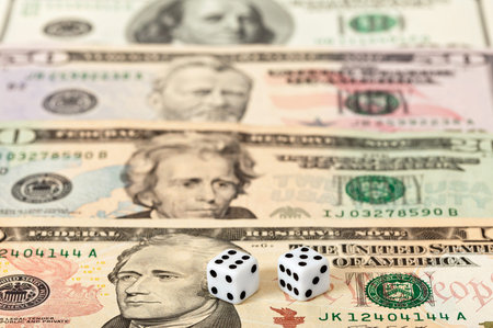 Dices on money background - business concept