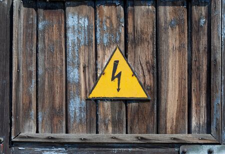 Old high voltage warning signの写真素材