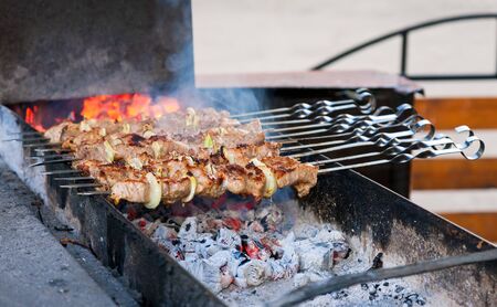 Juicy slices of meat with sauce prepare on fire  shish kebab  の写真素材