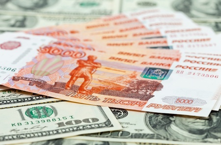 Russian roubles bills laying over dollars backgroundの写真素材